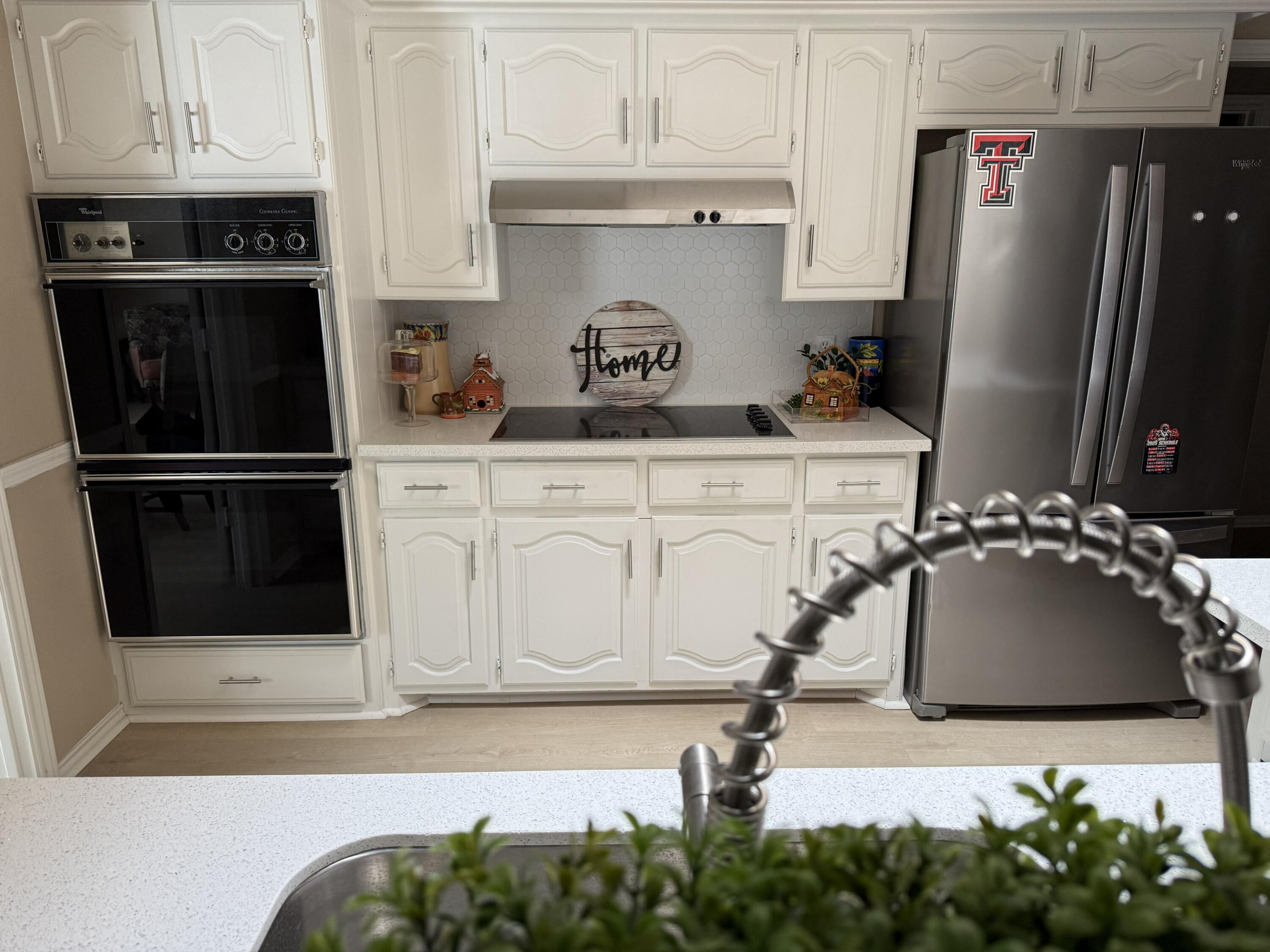 5722 75th Street Lubbock, TX 79424 - Photo 4 of 29 a kitchen with stainless steel appliances granite countertop a refrigerator and a stove