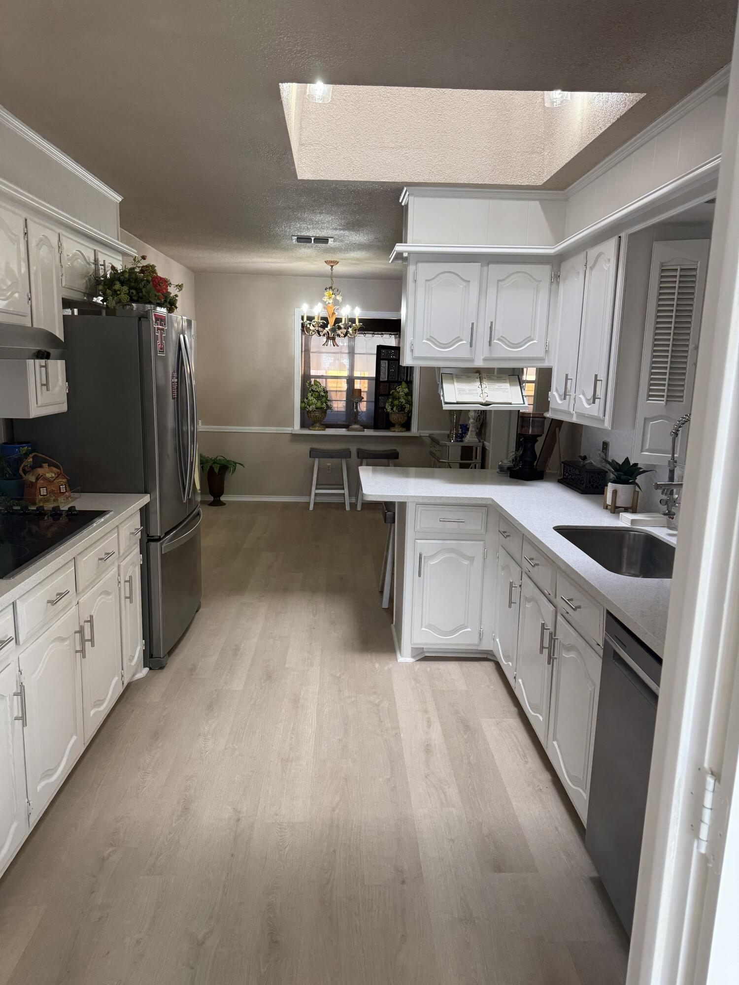 5722 75th Street Lubbock, TX 79424 - Photo 6 of 29 a kitchen with appliances a sink and cabinets