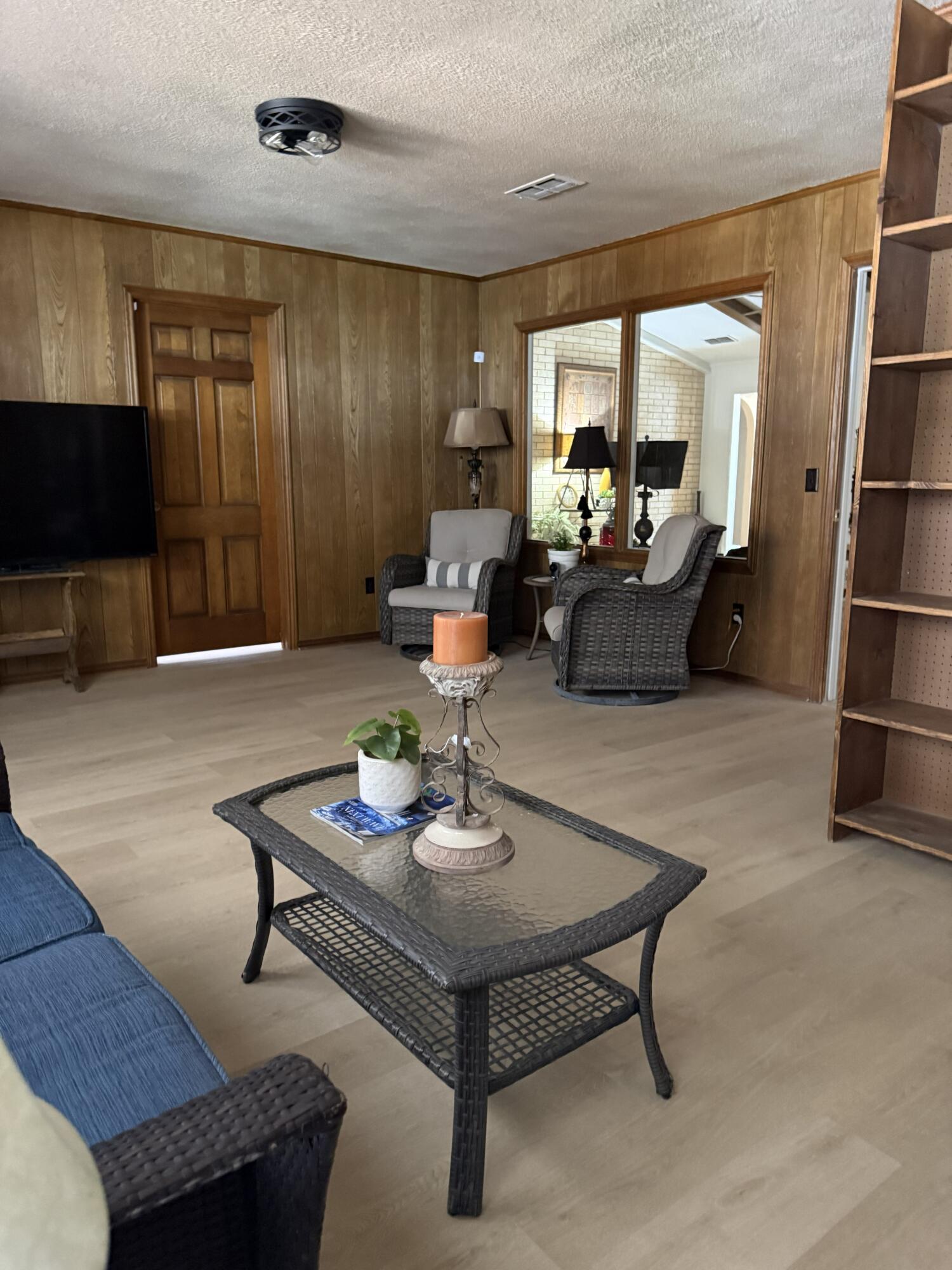 5722 75th Street Lubbock, TX 79424 - Photo 9 of 29 a living room with furniture and a flat screen tv