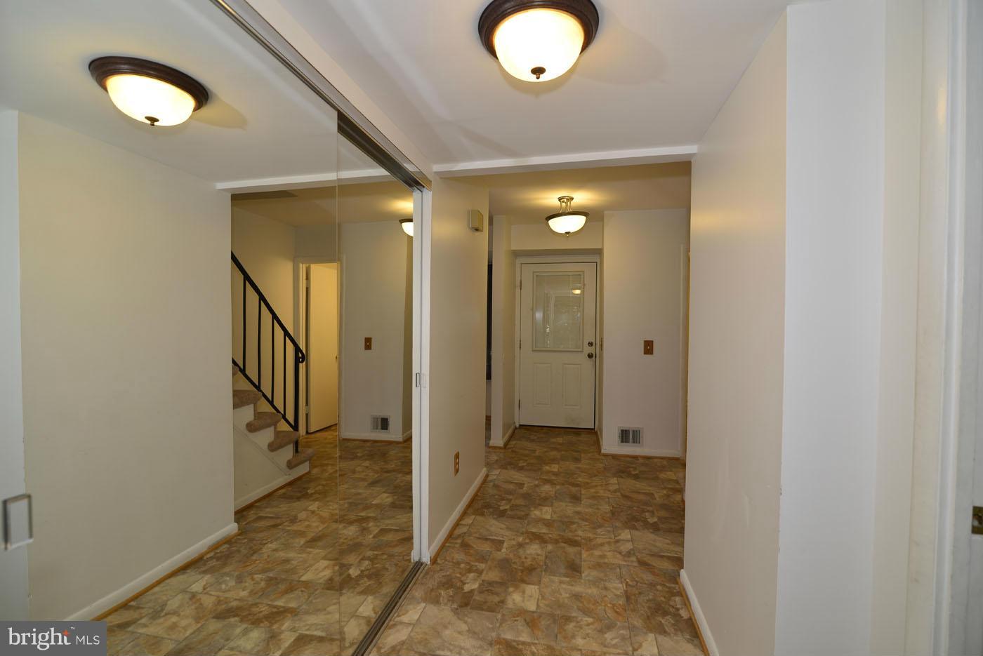 2373 Generation Drive Reston, VA 20191 - Photo 3 of 30 a view of a hallway with closet and wooden floor