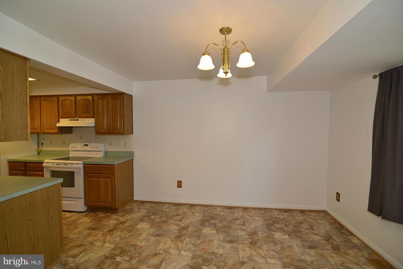 2373 Generation Drive Reston, VA 20191 - Photo 8 of 30 a view of a kitchen with a sink and dishwasher a stove top oven with wooden floor