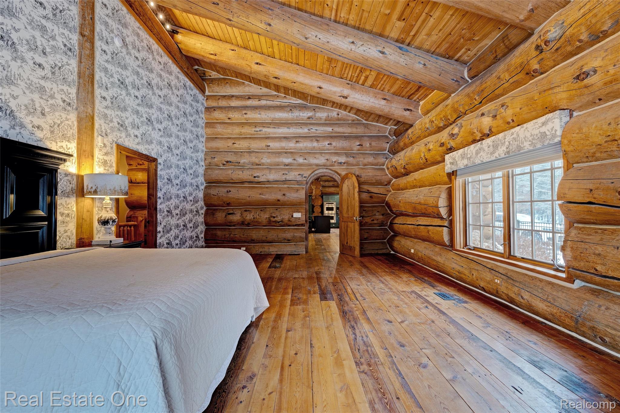 4340 Lahring Road Holly, MI 48442 - Photo 20 of 89 Bedroom featuring wood-type flooring, arched walkways, rustic walls, and wood ceiling