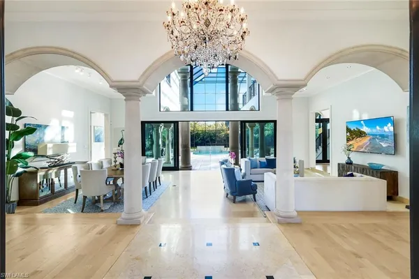 a living room with furniture and large windows