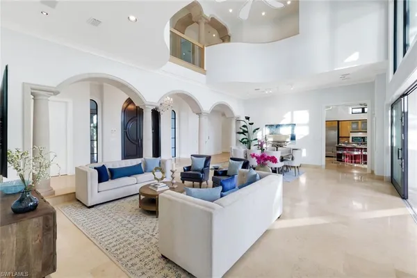 a living room with fireplace furniture and dining table