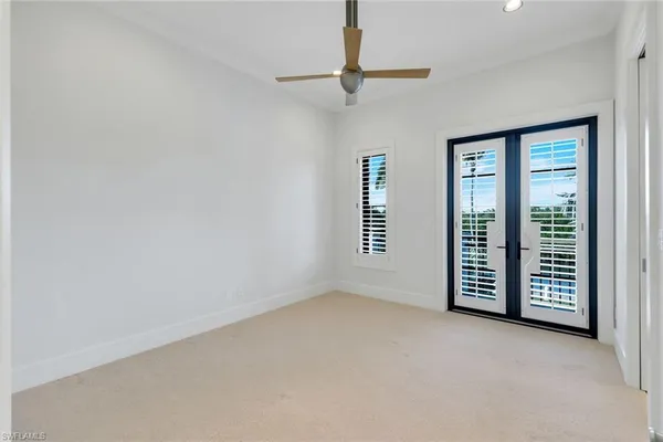 an empty room with furniture and windows