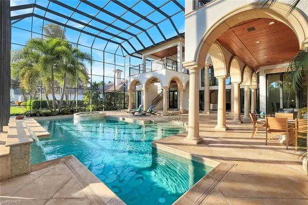 a view of swimming pool with outdoor seating and plants