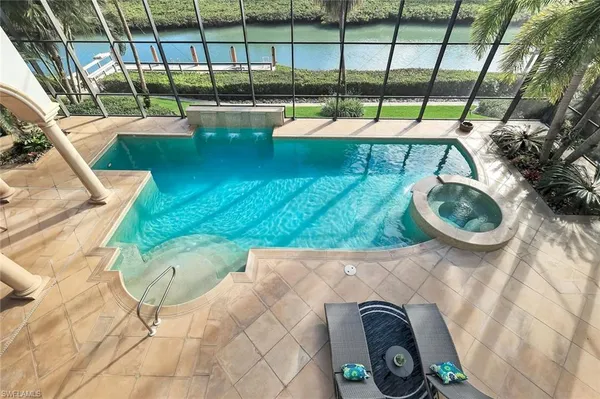 a view of swimming pool with outdoor seating and city view