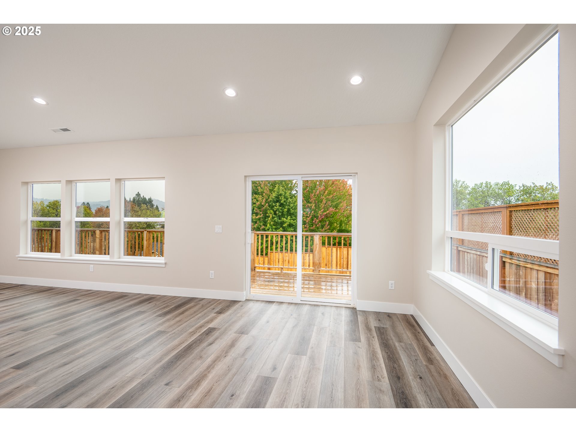 160 Wil Way Winston, OR 97496 - Photo 11 of 37 a view of an empty room with wooden floor and a window