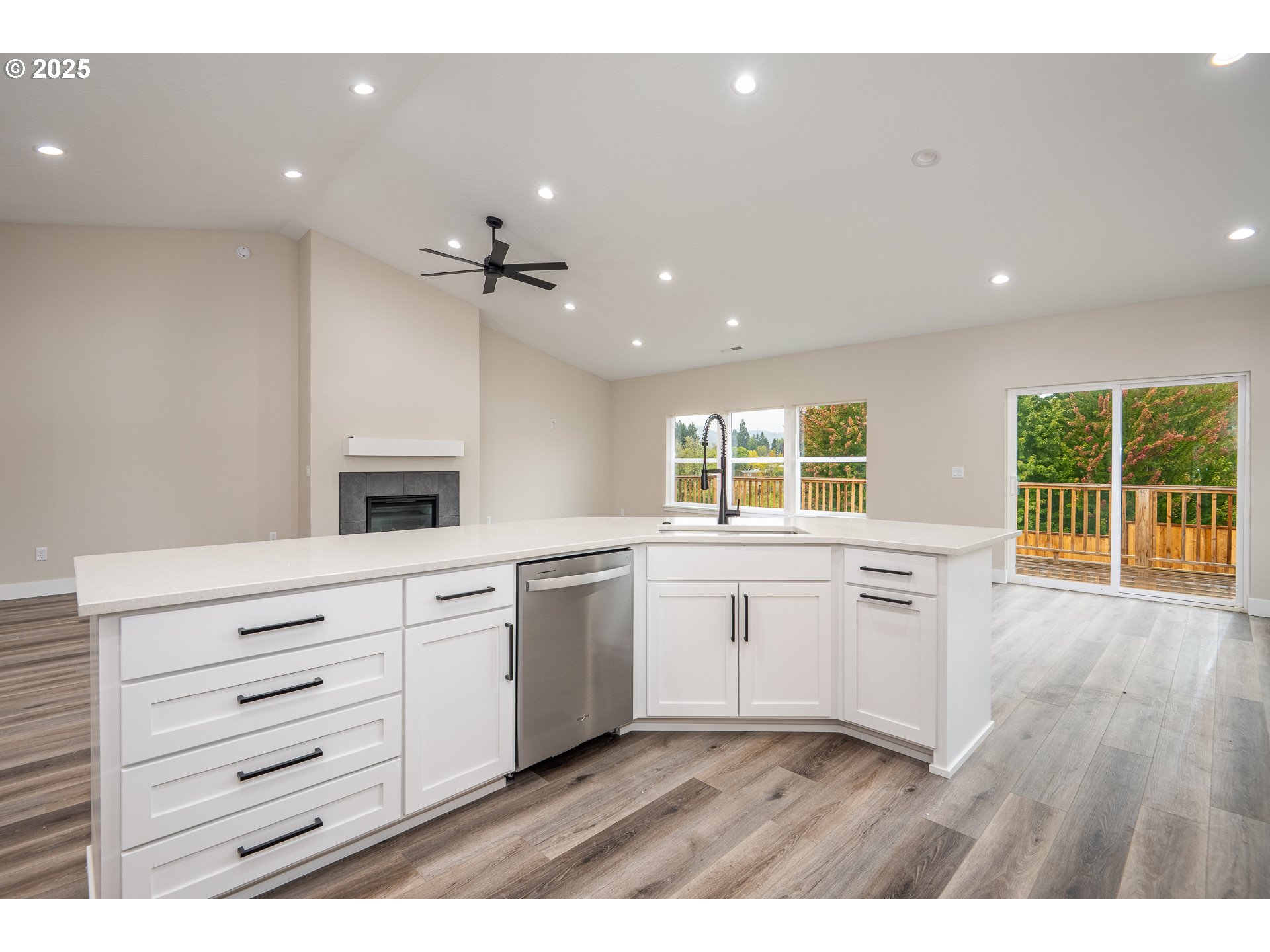 160 Wil Way Winston, OR 97496 - Photo 12 of 37 a open kitchen with granite countertop a stove top oven a sink and dishwasher with wooden floor