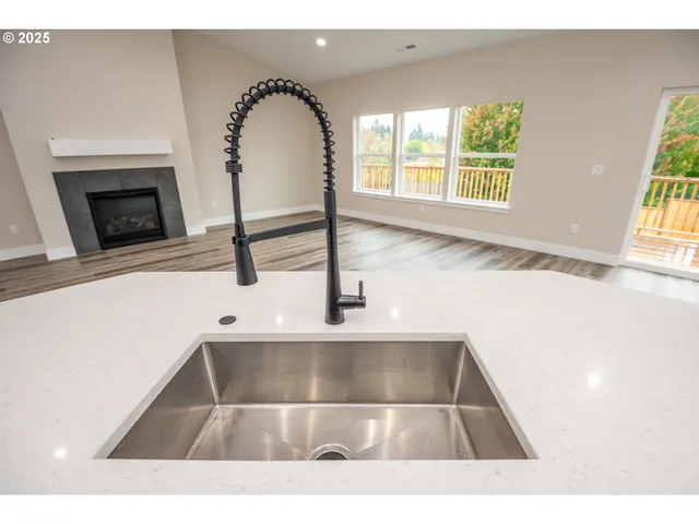 a living room with a sink and a fireplace