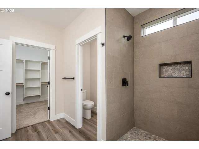 a bathroom with a shower toilet and a sink