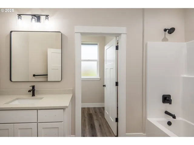 a bathroom with a sink a mirror and shower