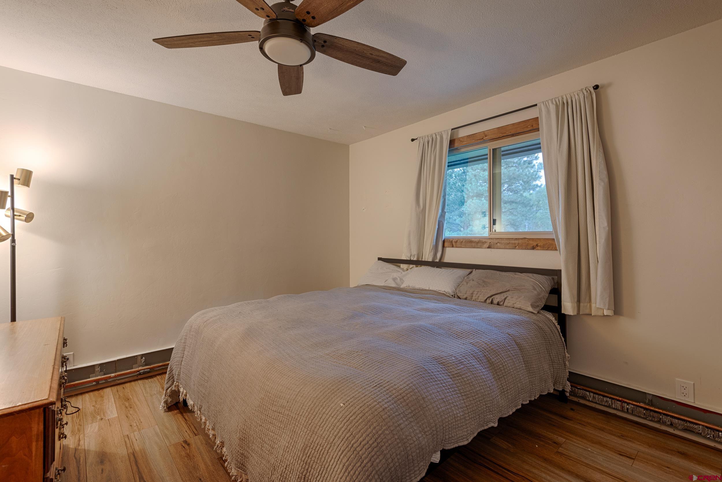 559 Suzanne Lane Ridgway, CO 81432 - Photo 27 of 45 a bedroom with a bed and a window