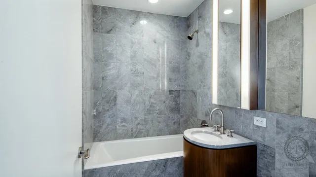 a white toilet sitting next to a bathroom sink