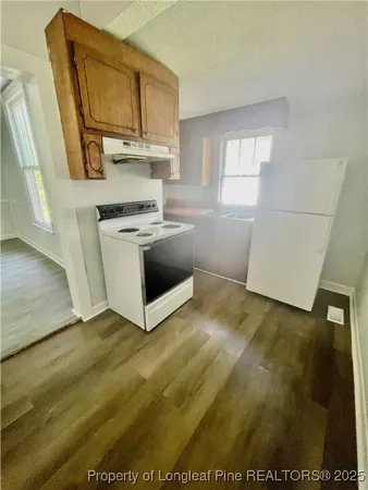 a kitchen with a sink and a stove top oven