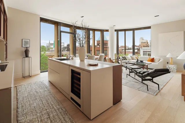 a living room with furniture and floor to ceiling windows