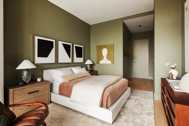 a spacious bedroom with a bed and a large window