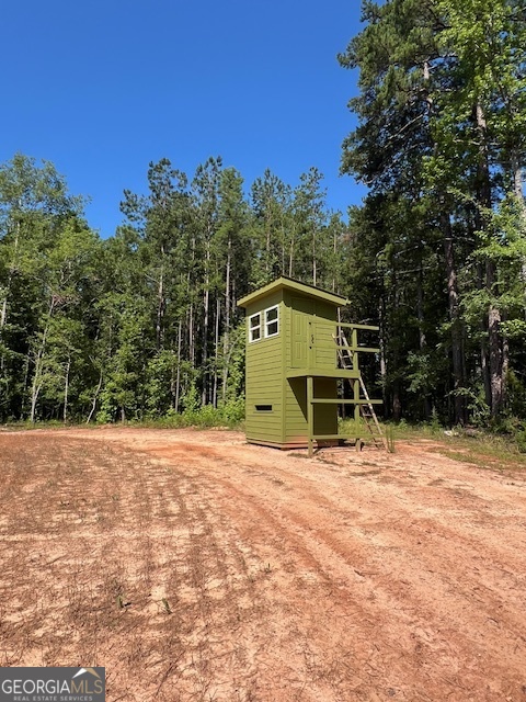 4348 Marshall Stewart Road Southwest Crawfordville, GA 30631 - Photo 106 of 120 a view of a wooden house with a yard