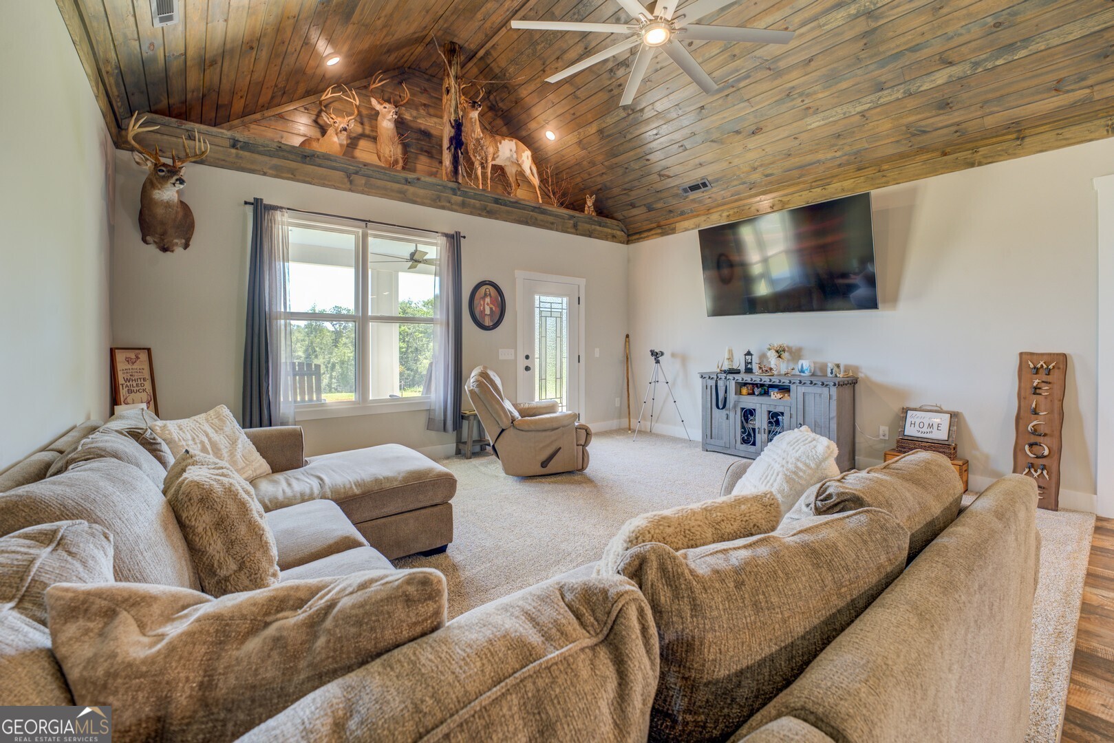 4348 Marshall Stewart Road Southwest Crawfordville, GA 30631 - Photo 24 of 120 a living room with furniture and a flat screen tv