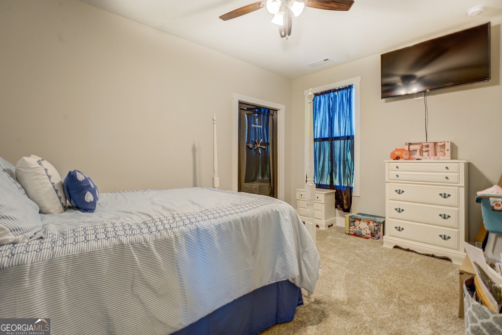 4348 Marshall Stewart Road Southwest Crawfordville, GA 30631 - Photo 35 of 120 a bedroom with a bed and a flat screen tv