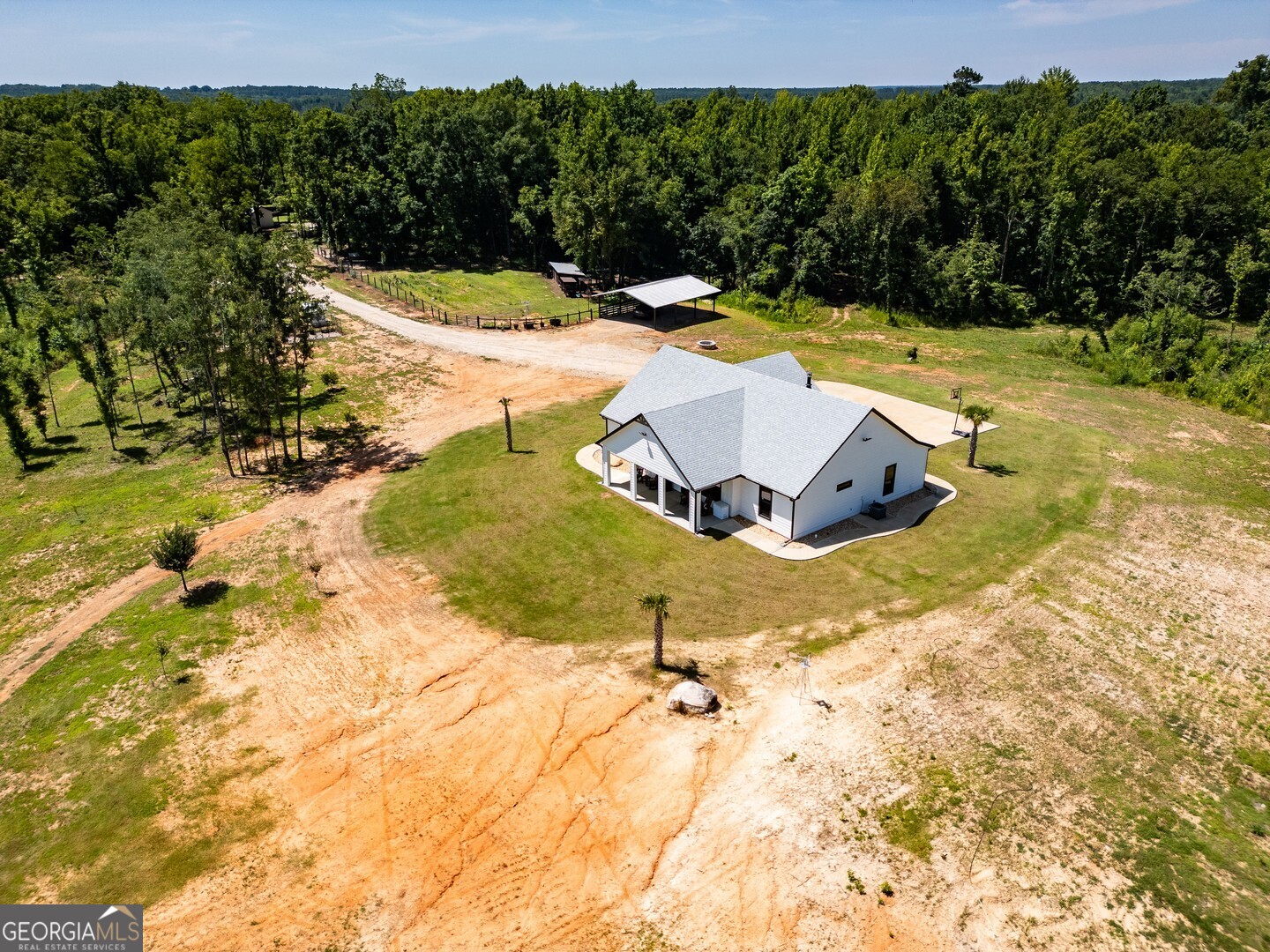 4348 Marshall Stewart Road Southwest Crawfordville, GA 30631 - Photo 46 of 120 a view of a swimming pool with an outdoor space and seating area