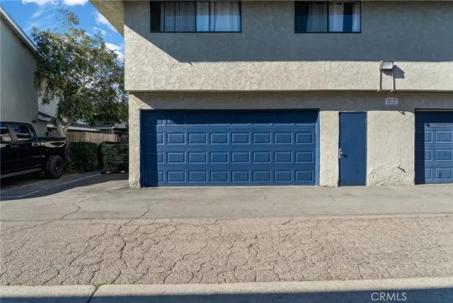a front view of a house with a road