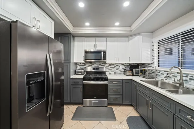 a kitchen with a sink stainless steel appliances and cabinets