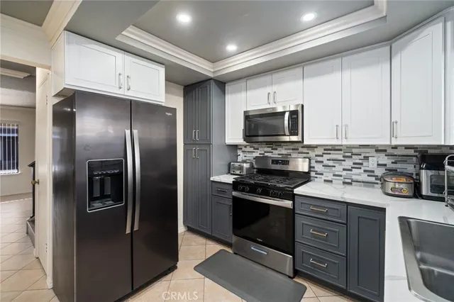 a kitchen with stainless steel appliances and granite countertop