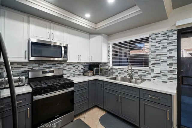 a kitchen with stainless steel appliances a stove sink microwave and cabinets