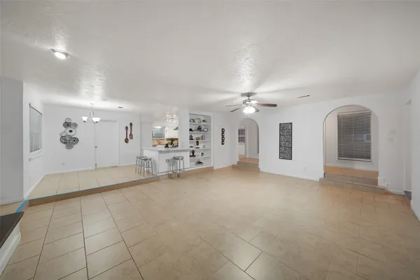 a view of a livingroom with furniture and chandelier fan