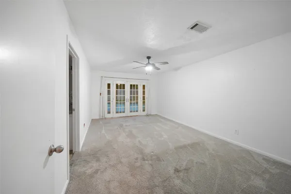 an empty room with windows and closet