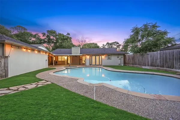 a view of a backyard with a swimming pool