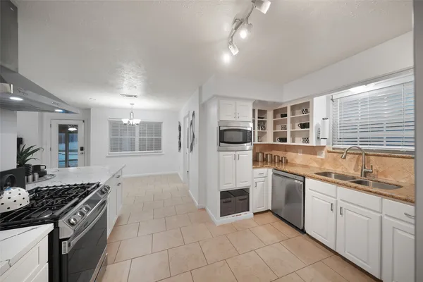 a kitchen with stainless steel appliances granite countertop a stove and a sink