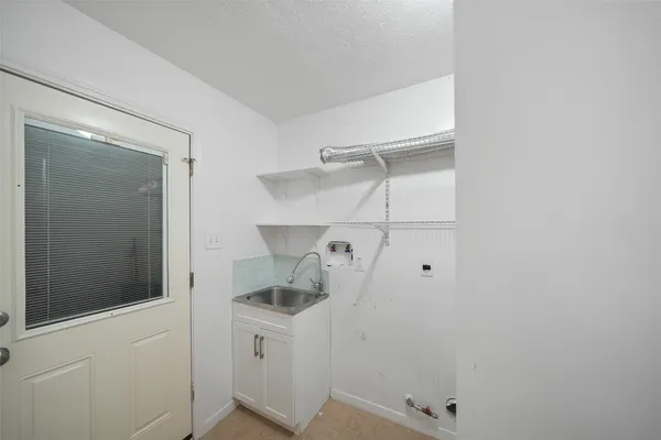 a view of storage and utility room with racks on the wall
