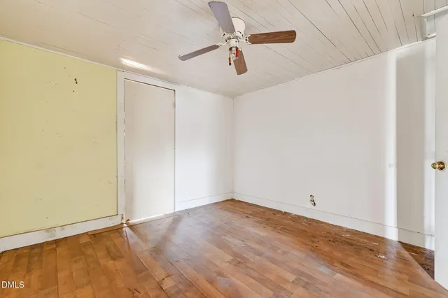 a view of a room with wooden floor