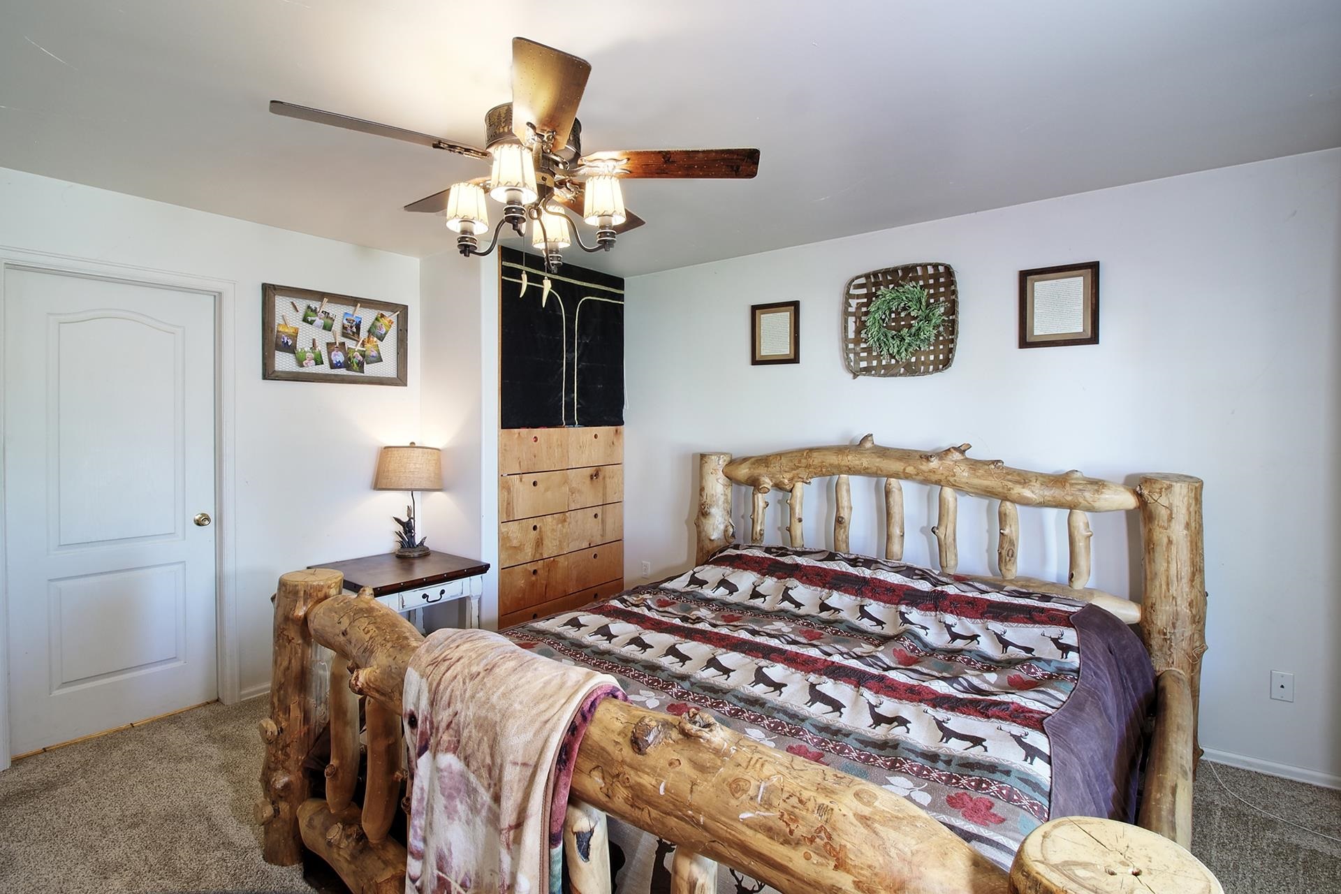 1742 10 Road Mack, CO 81525 - Photo 33 of 42 a bedroom with furniture and a chandelier