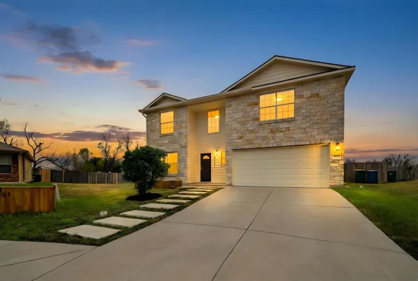 a front view of a house with a yard
