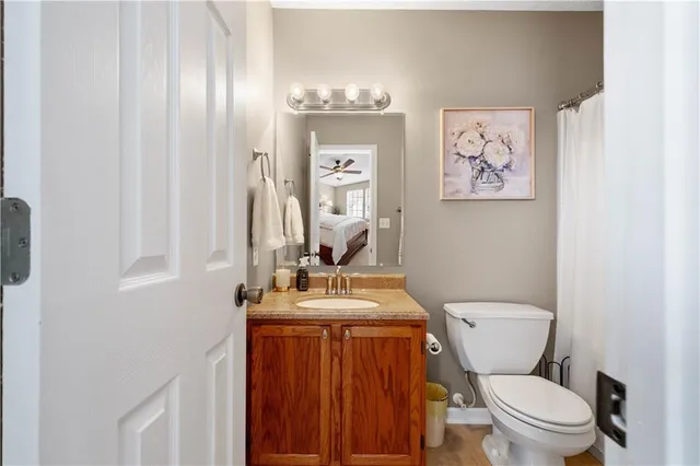 a bathroom with a toilet a sink and mirror