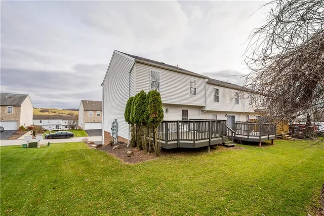 a view of a house with a yard and sitting area