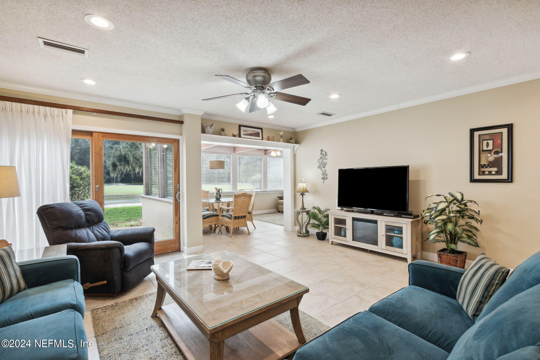 3327 Sea Marsh Road Fernandina Beach, FL 32034 - Photo 12 of 39 a living room with furniture and a flat screen tv