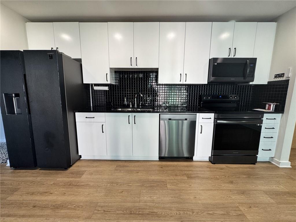 250 Pharr Road Northeast, Unit 601 Atlanta, GA 30305 - Photo 5 of 34 a kitchen with stainless steel appliances granite countertop a refrigerator and a stove top oven