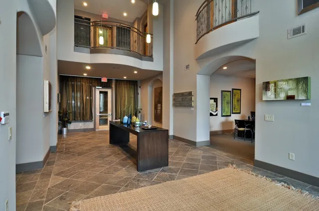 a lobby with furniture and mirror