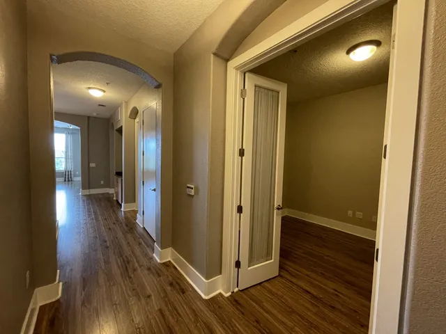 a view of a hallway with wooden floor