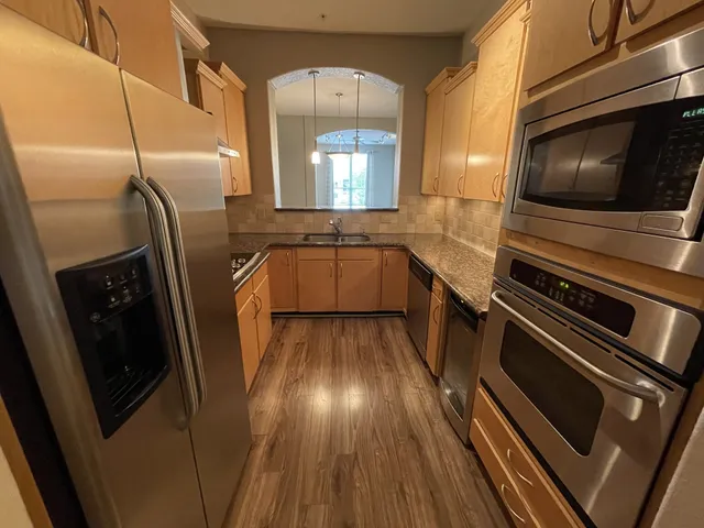 a kitchen with a sink a microwave a stove and refrigerator
