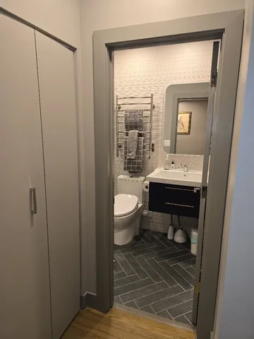 a bathroom with a toilet a sink and a mirror