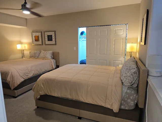 a bedroom with two beds and painted walls