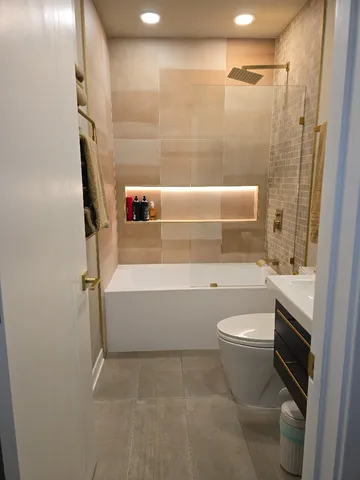 a bathroom with a toilet a sink and bathtub