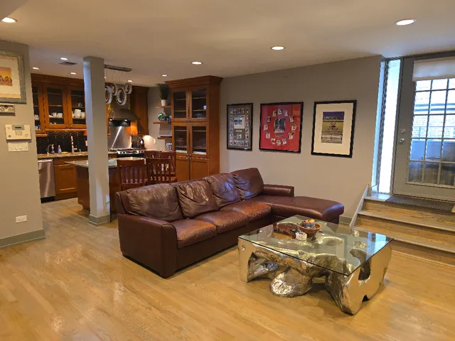 a living room with furniture and kitchen view