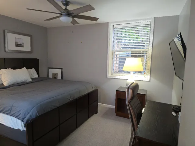 a bedroom with a bed and a window