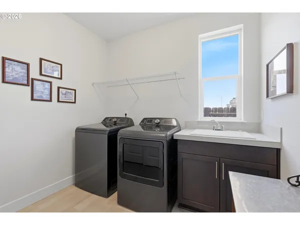 a utility room with sink dryer and washer